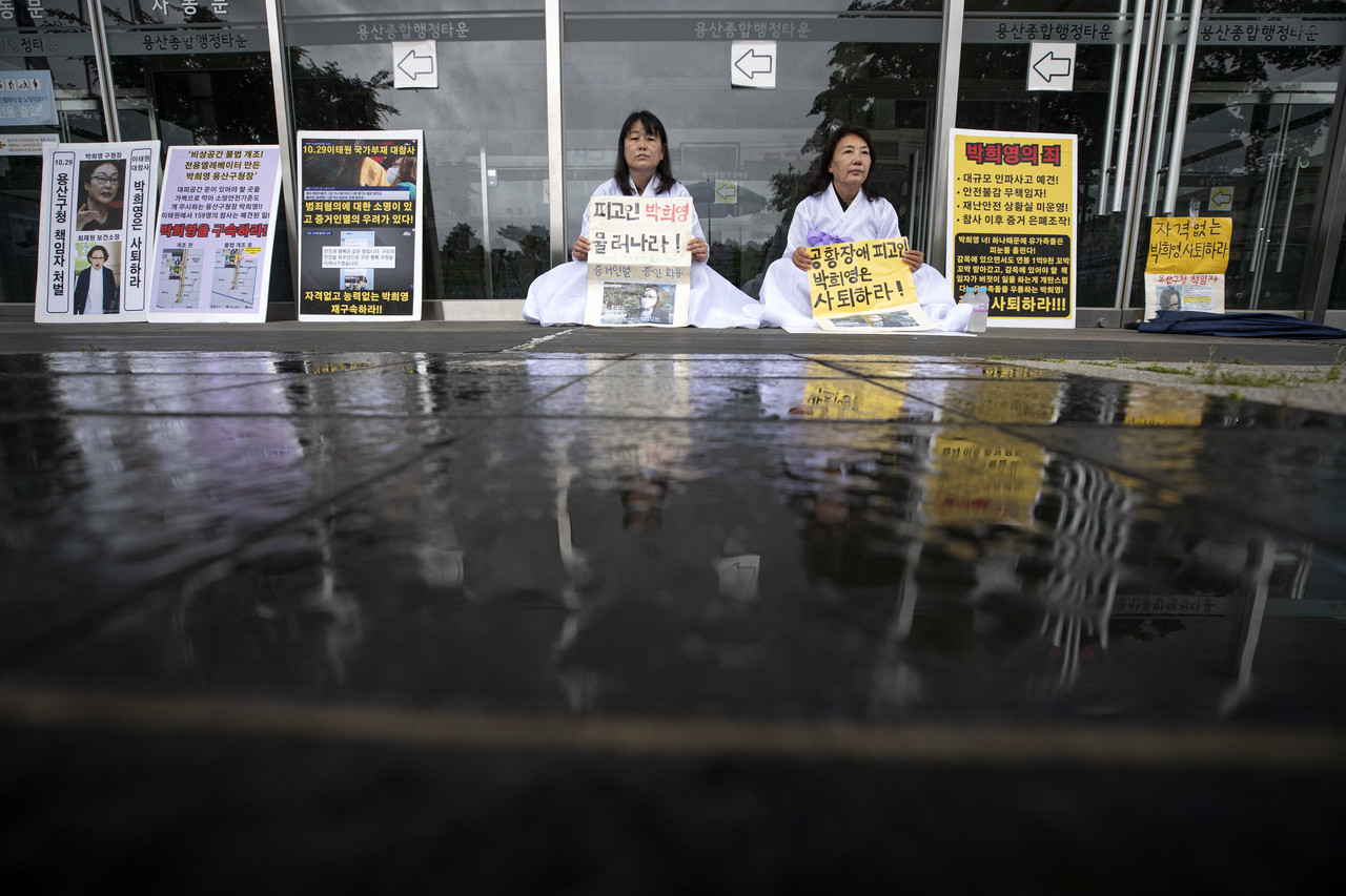 이태원 참사 유가족들이 박희영 용산구청장의 사퇴를 촉구하며 서울 용산구청 앞에서 흰 소복을 입고 출입문 앞에 앉아있다. ⓒ시사IN 박미소